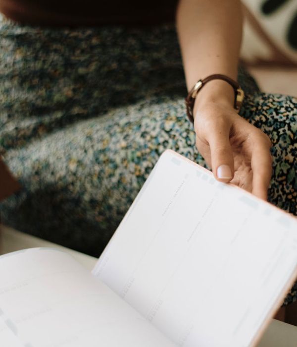 Image of a daily planner and a watch indicating schedule.